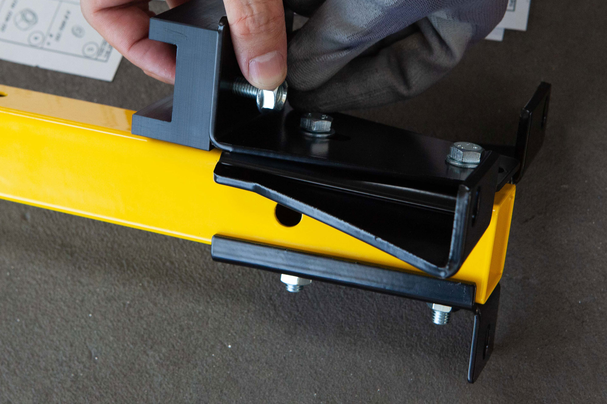 Closeup shot of an operator assemblying the adjustable baseplate of Satech Safety Fences