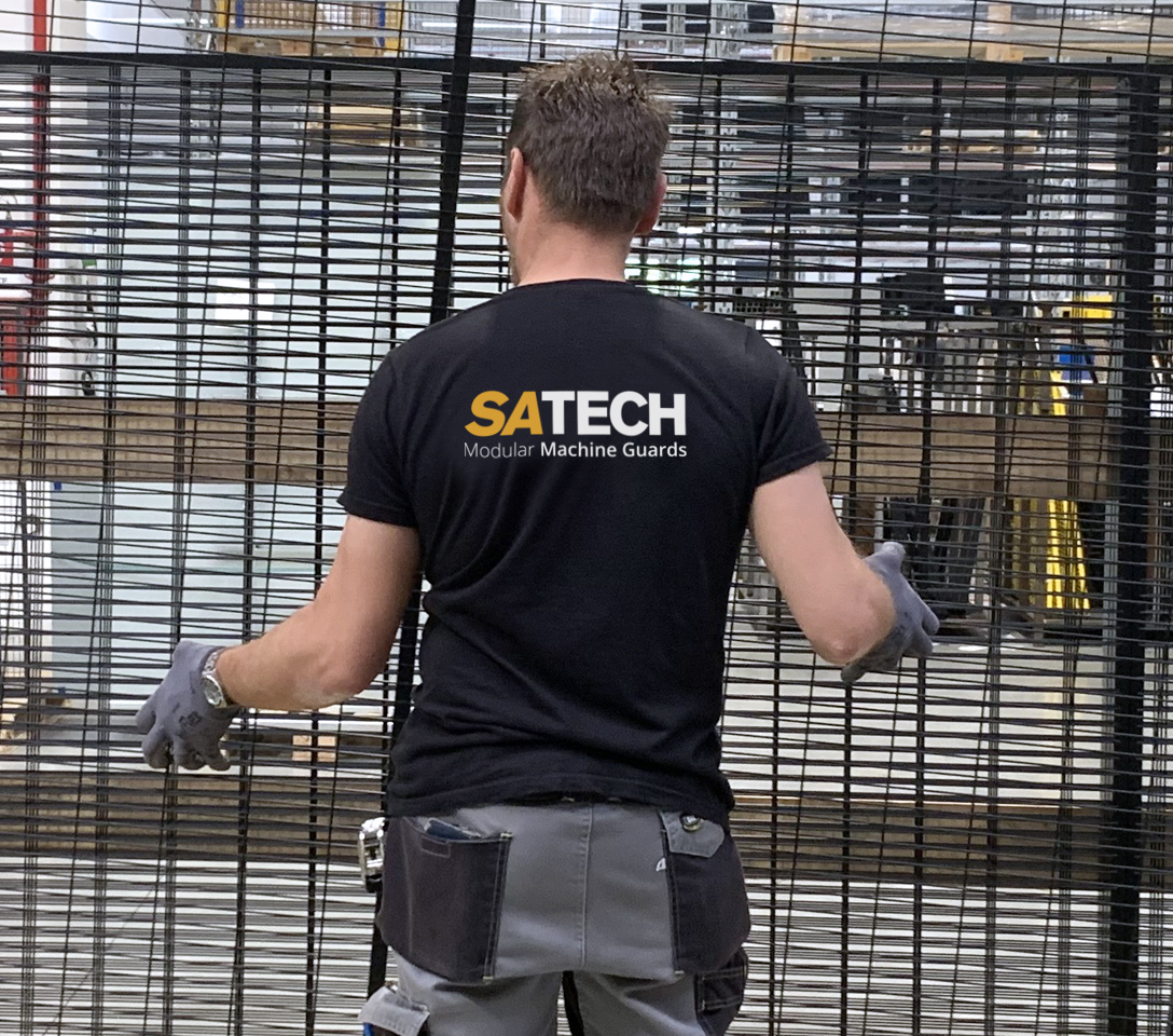 Operator handling the lightweight framed mesh Satech panel