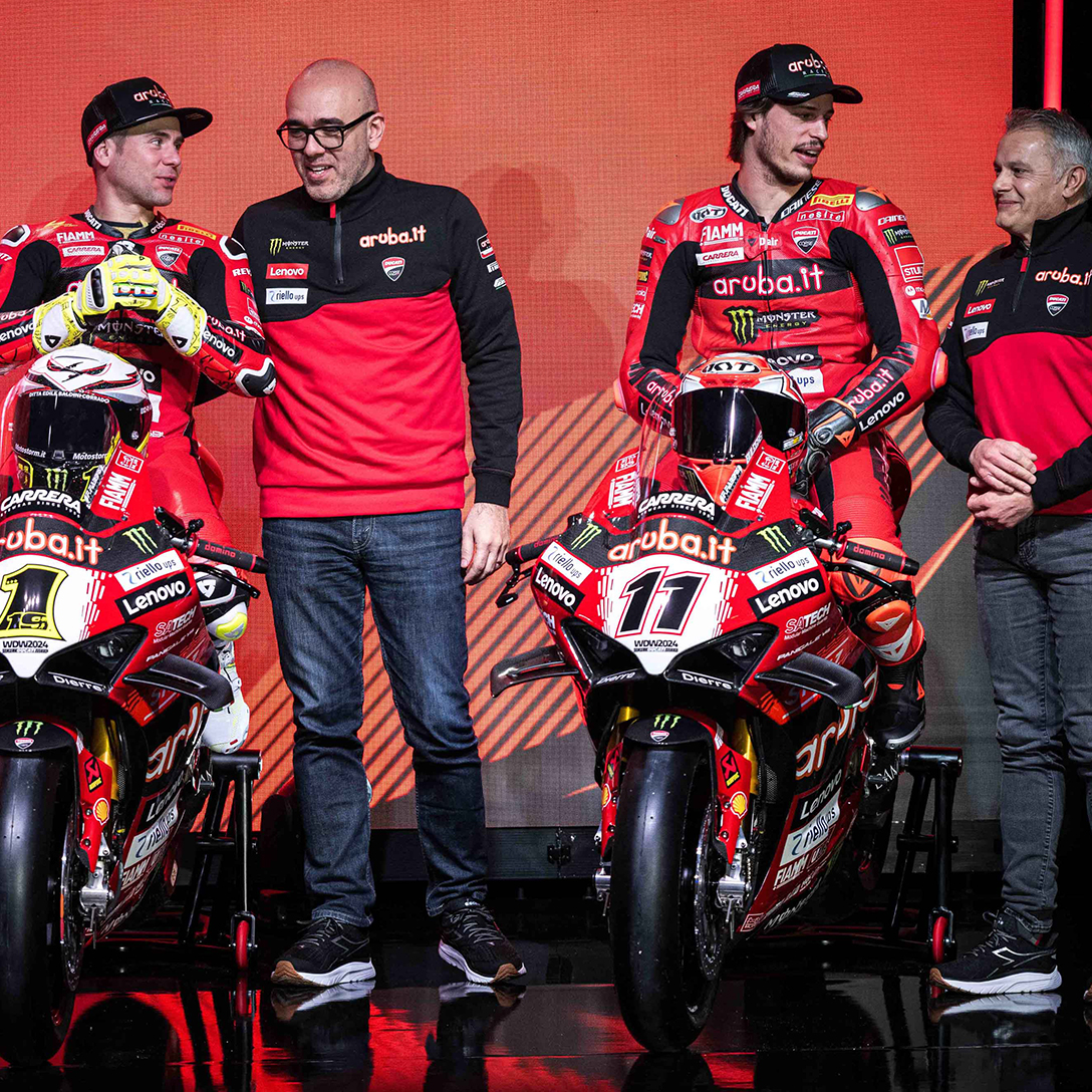 Alvaro Bautista and Nicolò Bulega talking to the Aruba.it Racing - Ducati Superbike Team staff while standing on their motorbikes