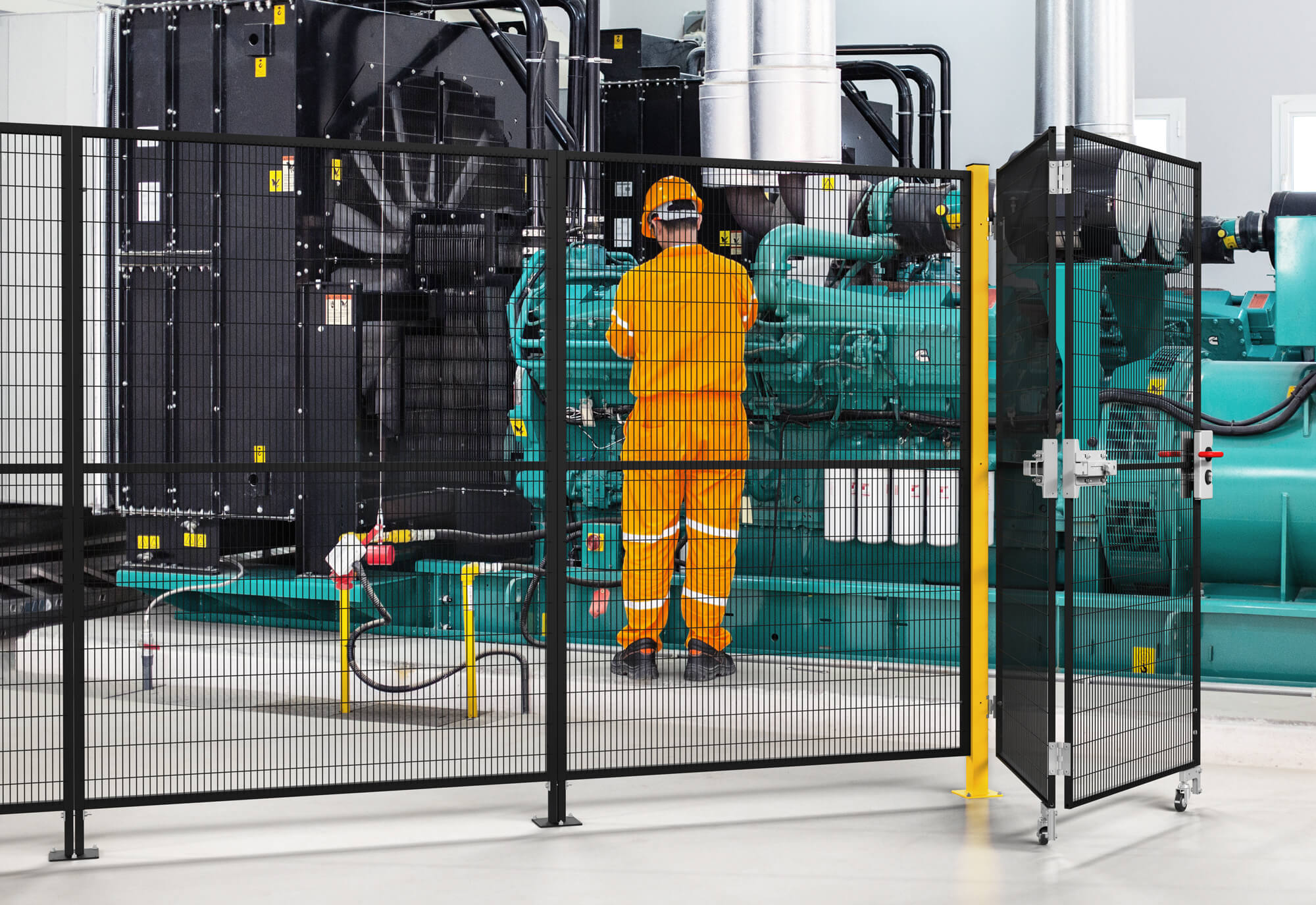 Mid-distance shot of a folding door by Satech placed around machinery