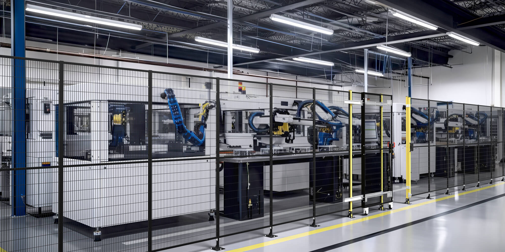 Mid-distance shot of a Satech FastGuard line installed around robots and machinery